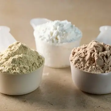 Three scoops of different high protein low carb protein powders