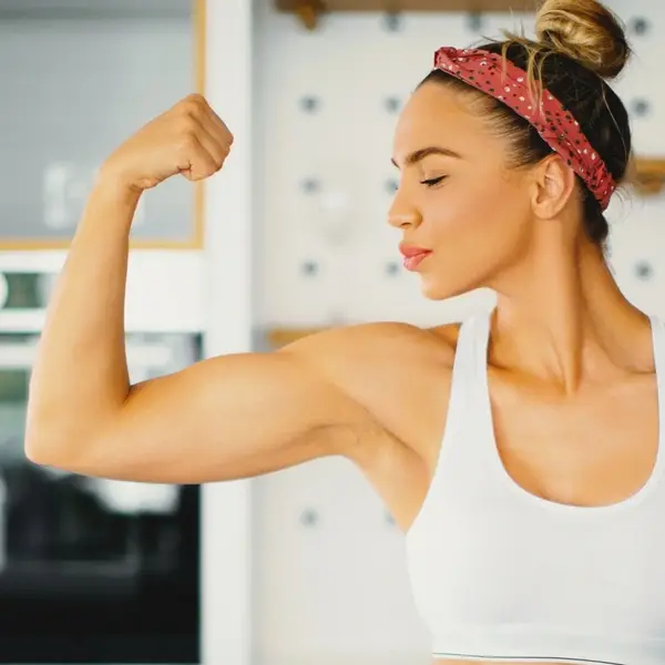 Fit woman flexing her bicep muscle after a workout