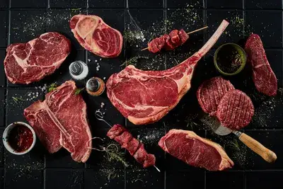 Assortment of raw beef cuts including ribeye and tomahawk steak