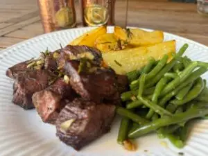 BBQ garlic butter steak skewers served with crispy potatoes and grilled green beans