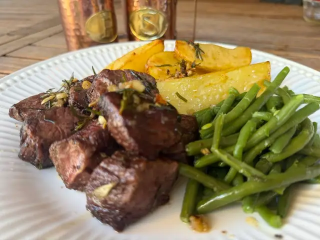 BBQ garlic butter steak skewers served with crispy potatoes and grilled green beans